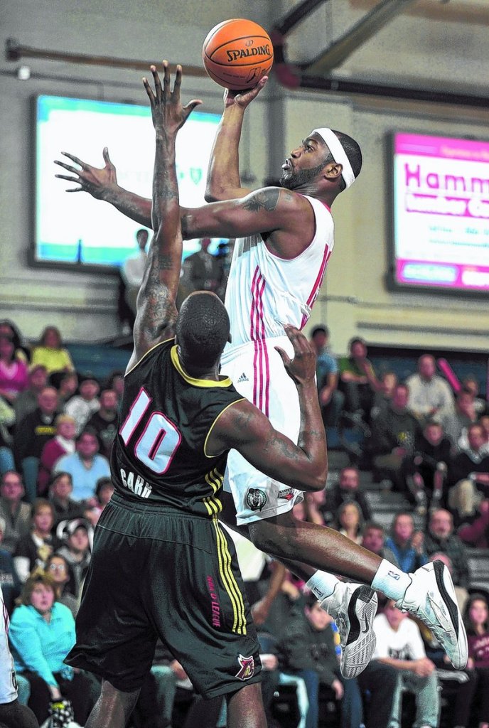 Mario West of the Maine Red Claws heads to the basket Friday night over Tasheed Carr of the Erie Bay Hawks during Erie's 123-109 victory at the Portland Expo.