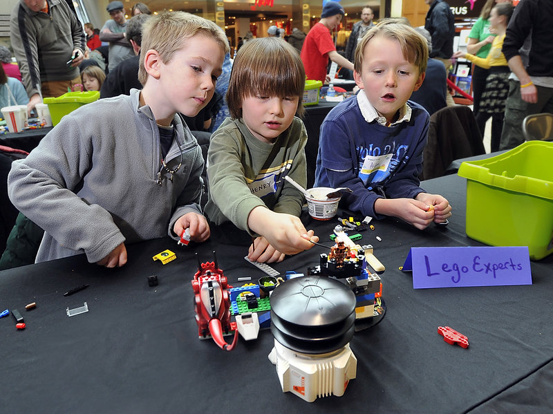 Camdyn Morrill, 6, left, Henry Moore, 6, and Aidan Clay, 7, all of South Portland, build a futuristic house at a LEGO House Build-a-thon fund-raiser at the Maine Mall in South Portland on Saturday.
