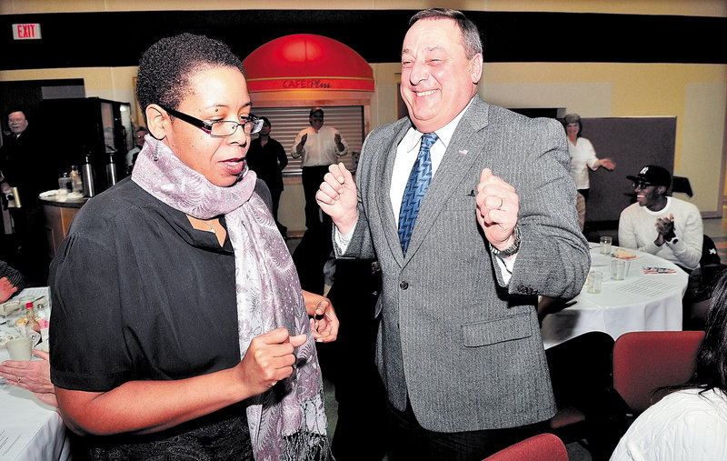 Martin Luther King Jr. Day keynote speaker the Rev. Effie McClain of Oakland and Gov. Paul LePage dance during a community breakfast in Waterville on Monday, with music from the Colby College African Drummers Ensemble.