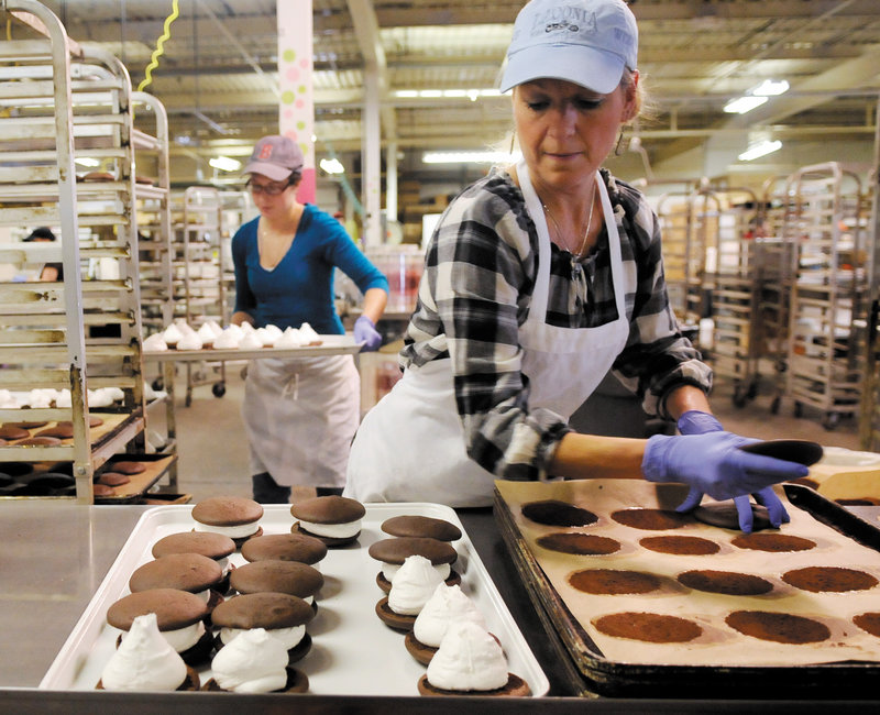 Diane Bouchard, right, and Kristen Averell prepare whoopie pies Friday at Isamax Snacks in Gardiner. A supporter of a proposal to make whoopie pies the official state dessert notes that Maine already has an official soft drink, Moxie.