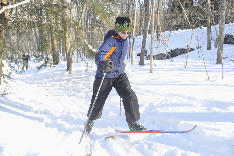Devon Pierce, 10, of Phippsburg climbs a small hill while skiing on the new trails.