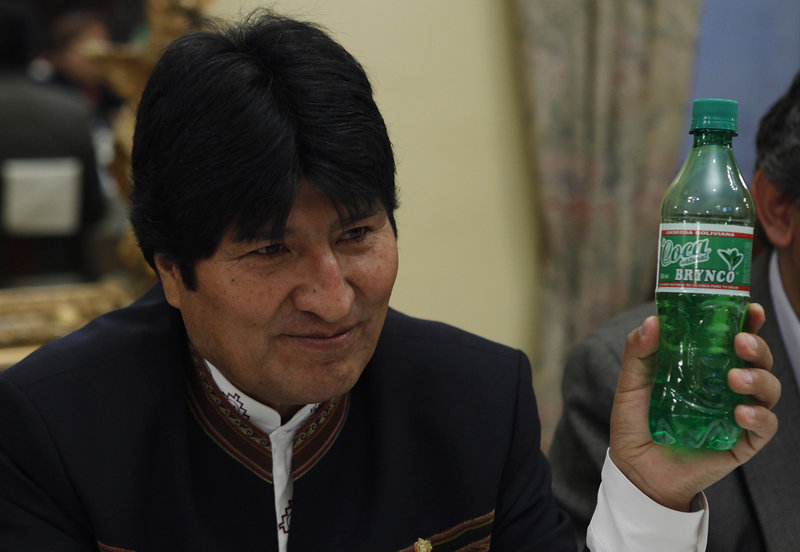 President Evo Morales holds a bottle of Coca Brynco, a Bolivian soda made with coca leaves, during a meeting with foreign reporters last week in La Paz.
