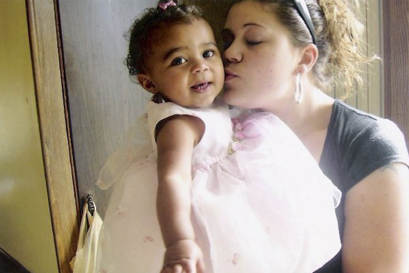 Megan Waterman kisses her daughter, Lily, now 4. Friends and family say Waterman agreed to work as a prostitute at the urging of her boyfriend, Akeem Cruz.