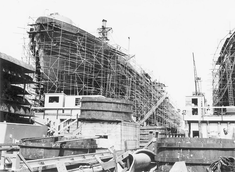 An archival photo shows a Liberty ship under construction.