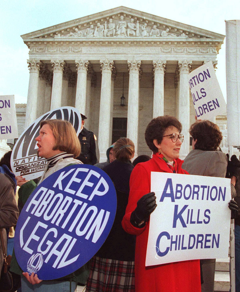 Protesters on both sides of the abortion issue hold signs outside the U.S. Supreme Court during the 2006 March for Life demonstration.