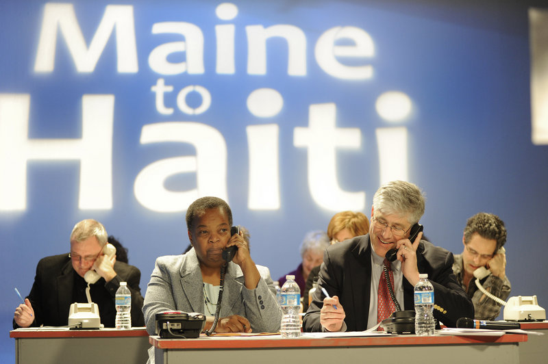 Portland City Councilor Jill Duson and Mayor Nicholas Mavodones volunteer to accept donations during the “From Maine to Haiti, One Year Later,” telethon at the WGME-TV Channel 13 studio in Portland on Friday.