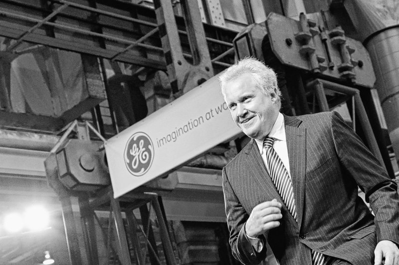 General Electric CEO Jeffrey Immelt strides to the stage Friday at the GE plant in Schenectady, N.Y., to introduce President Obama. Obama announced a restructured presidential board to be led by Immelt that focuses on increasing employment and competitiveness. GE’s fourth-quarter profit climbed 51 percent, and revenue also beat analysts’ expectations.