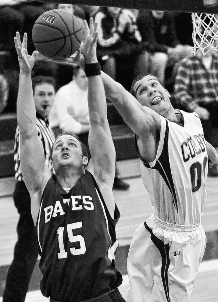 Alex Gallant of Bates battles for the rebound with Colby’s Mike Russell during Friday night’s game at Waterville. Colby tied the game with three seconds left in regulation, then won 75-69 in overtime.