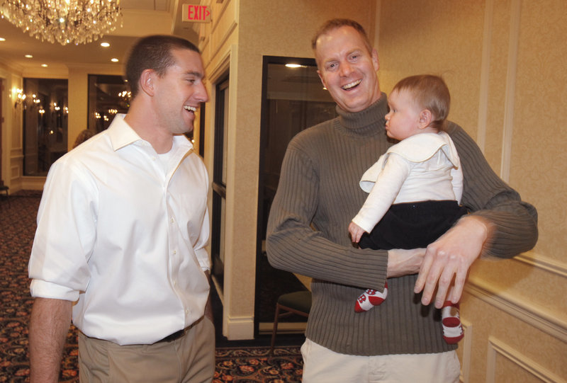Ryan Kalish, left, a former Sea Dog who spent part of last season with the Red Sox, talks with Mark Nielsen and his son Nevyn at the Sea Dogs' annual hot stove dinner Friday night.