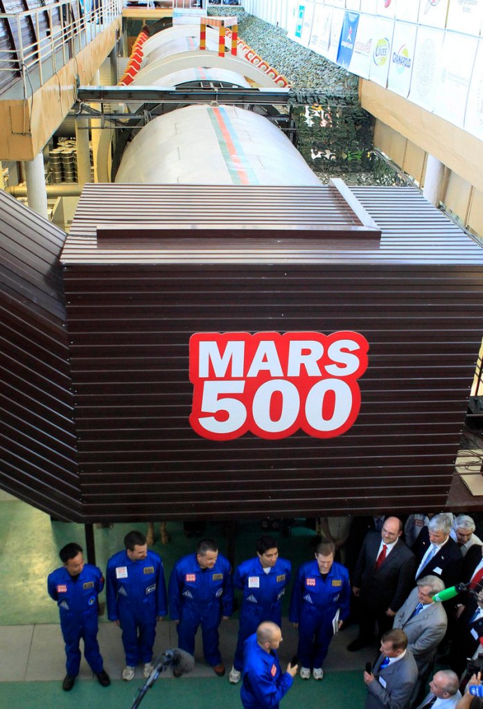 Six researchers, dressed in blue, prepare on June 3, 2010, to enter the steel capsule in which a space flight to Mars will be simulated. The 520-day ‘flight’ is about half completed, and a ‘Mars landing’ is scheduled for Feb. 12.