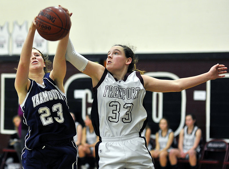 Sean Cahill, left, of Yarmouth competes with Aubrey Pennell of Freeport for a rebound Friday in the first half of Freeport’s 42-31 victory in a Western Maine Conference game at home.
