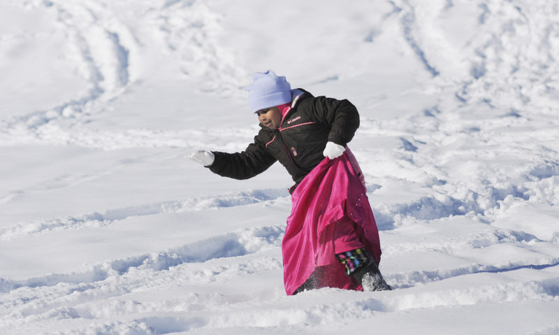 Amal Salaad, 5, of Portland, whose family is from Somalia, takes a careful step in the snow while wearing snowshoes at Payson Park in Portland as part of Saturday’s WinterKids event. The Welcome to Winter Festival drew about 300 people to Payson Hill.