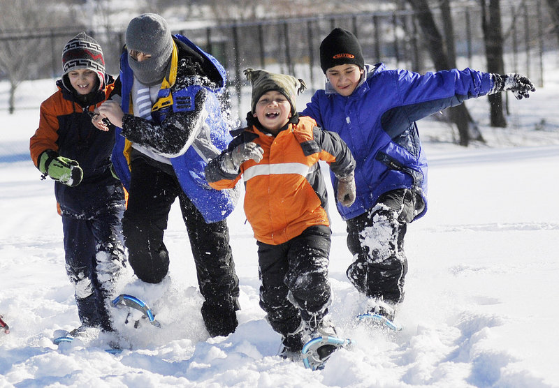 Iraqi immigrants, from left, Salar Salim, 9, Salim Salim, 12, Khalil Mohammad Sheet, 7, and Mohammad Sheet, 11, play in the snow at the 7th annual Welcome to Winter Festival hosted by WinterKids in Payson Park on Saturday.