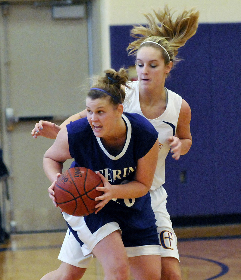 Kayla Burchill of Deering looks for an open teammate Saturday while guarded by Brooke Flaherty of Cheverus. Burchill scored 24 points to help the Rams remain undefeated with a 56-44 victory at Cheverus High.