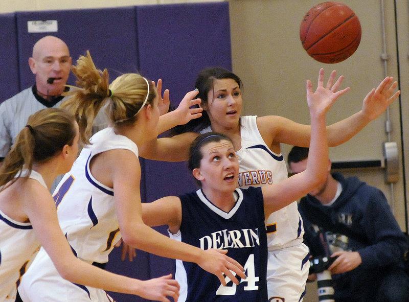 Ella Ramonas of Deering has her eyes on a loose ball while surrounded by Cheverus defenders, including Alexandra Palazzi-Leahy, right.