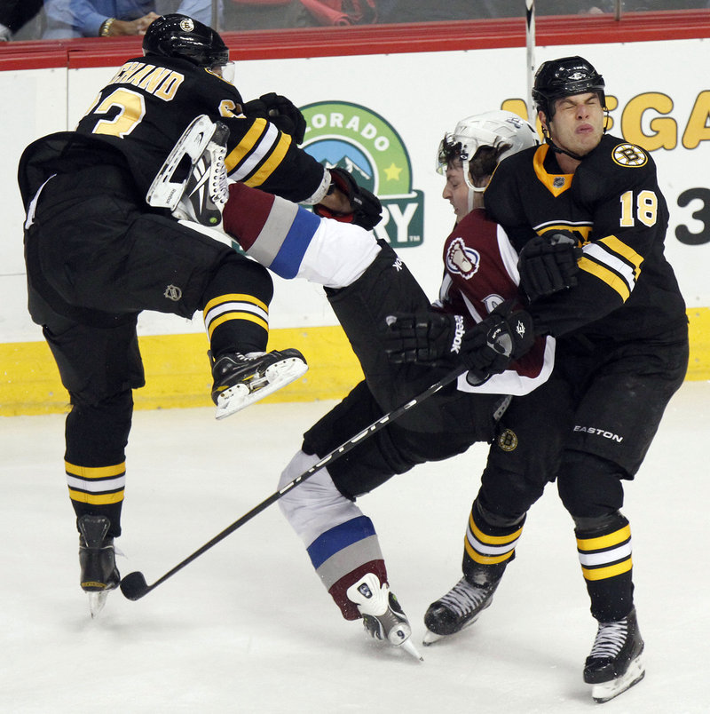 Boston’s Brad Marchand, left, and Nathan Horton collide with Colorado’s Matt Duchene during the Bruins’ 6-2 win Saturday. It was Boston’s third win in four games.