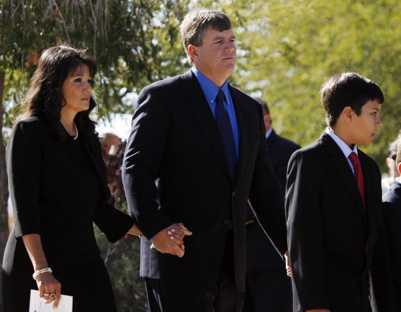 Roxanna and John Green arrive at a Tucson church Jan. 13 for the funeral of their 9-year-old daughter, Christina Taylor Green. With them is their son, Dallas.