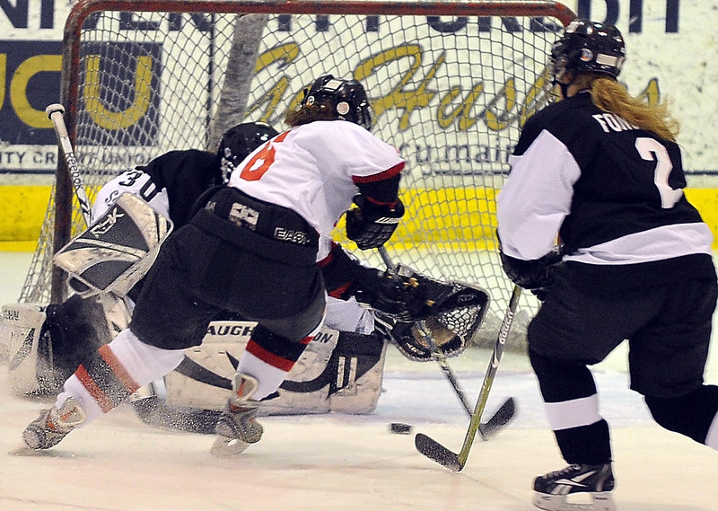 Abby Rutt of Scarborough moves the puck to her backhand before sliding it past St. Dom’s goalie Nicole Keaney during Monday’s game at USM Arena. Rutt’s goal tied the game at 2 late in the second period, but St. Dom’s eventually pulled out a 3-2 victory.