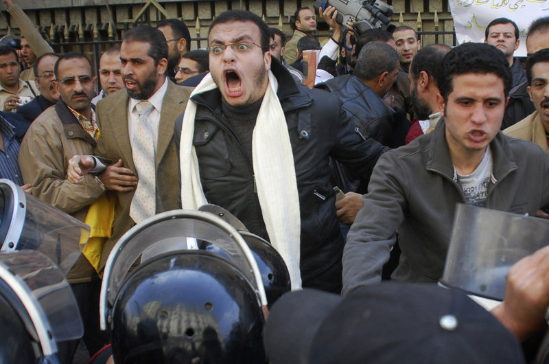 Protesters are confronted by riot police as they demonstrate in downtown Cairo on Tuesday. Hundreds of anti-government protesters marched in the Egyptian capital chanting against President Hosni Mubarak and calling for an end to poverty.