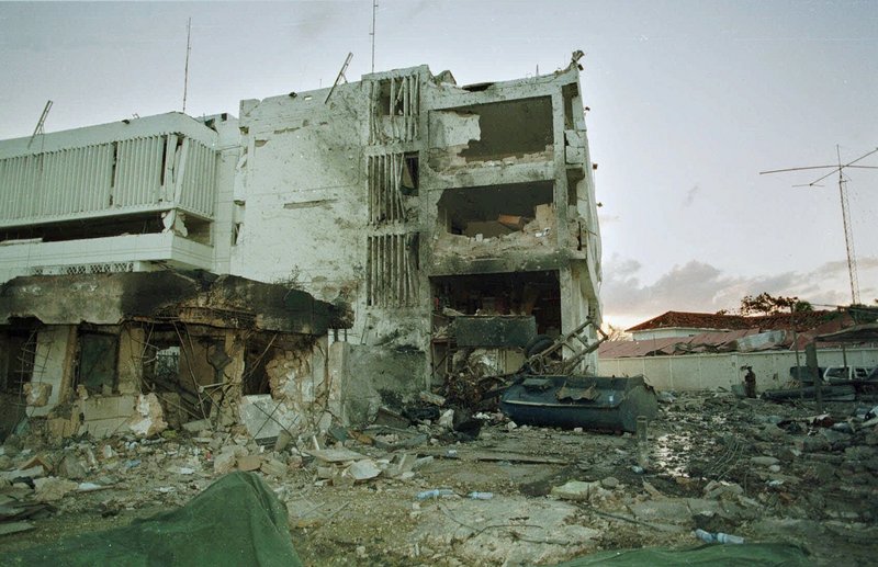 The burned-out wreckage of the U.S. Embassy in Tanzania is shown a day after the blast. Almost simultaneously, bombs hit U.S. embassies in Kenya and Tanzania, killing 224, including 12 Americans, and injuring thousands.