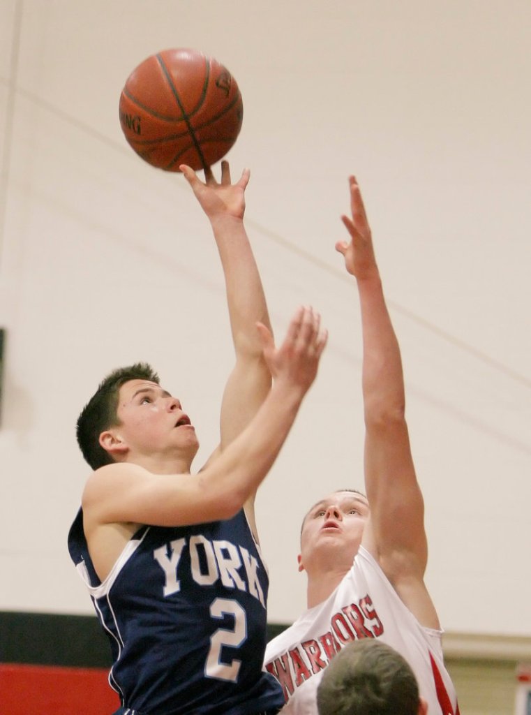 Thomas Kinton, who scored 10 points for York, puts up a shot Tuesday as Paul McDonough of Wells defends during York’s 50-31 victory at Wells High.