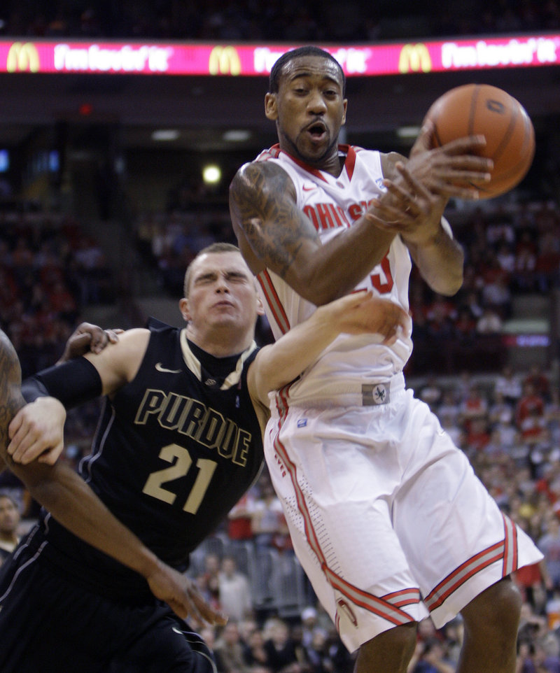 David Lighty, right, of Ohio State is fouled by Purdue’s D.J. Byrd while trying to grab a rebound during Ohio State’s 87-64 win Tuesday night at Columbus, Ohio.