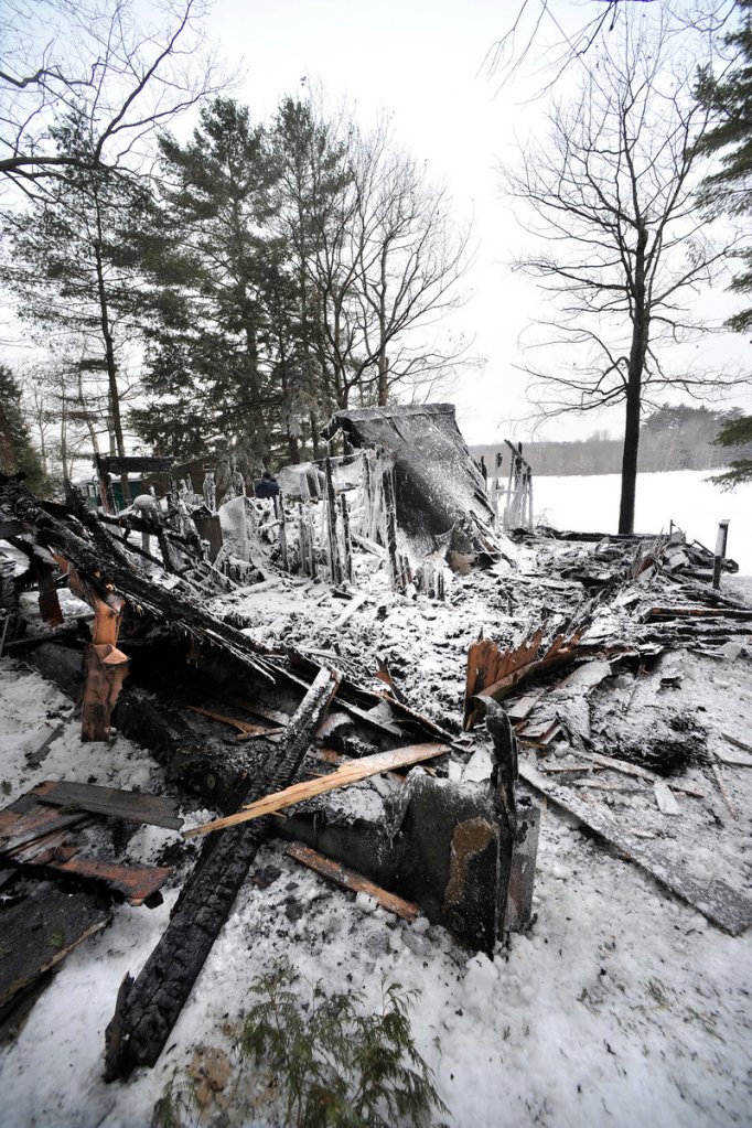 Charred debris remains after an early-morning house fire on Highland Lake. The occupants escaped safely.