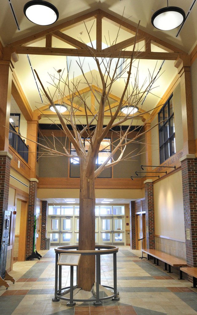 Aaron Stephan’s “RE: turn,” made of lumber from trees salvaged from the bottom of Moosehead Lake, stands in the atrium of Westbrook Middle School.