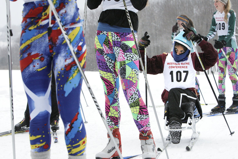 Christina Kouros adjusts her hat while waiting in a starting line at a Nordic ski competition at Pineland Farms in New Gloucester on Wednesday. Kouros, a Cape Elizabeth High School sophomore, competes on the team using a sit-ski.