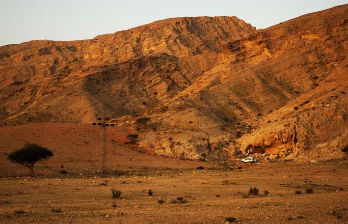 A photo provided by the journal Science shows a view of Jebel Faya from the northeast. Modern humans may have left Africa thousands of years earlier than previously thought, heading across the Red Sea into Arabia rather than down the Nile, researchers say.