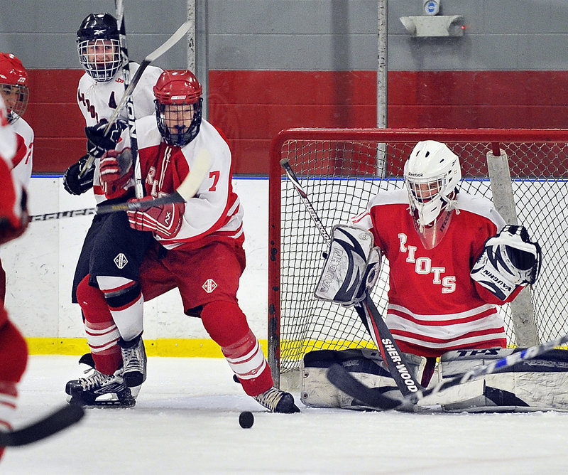 South Portland goalie Dominic Desjardins, and Josh Cobb, 7, keep their eyes on a loose puck in front. Scarborough scored three straight goals for a 3-1 victory.
