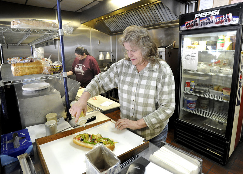 Sheila Cunningham assembles one of her last Italian sandwiches as an employee of Terroni's Market during her shift on Friday.