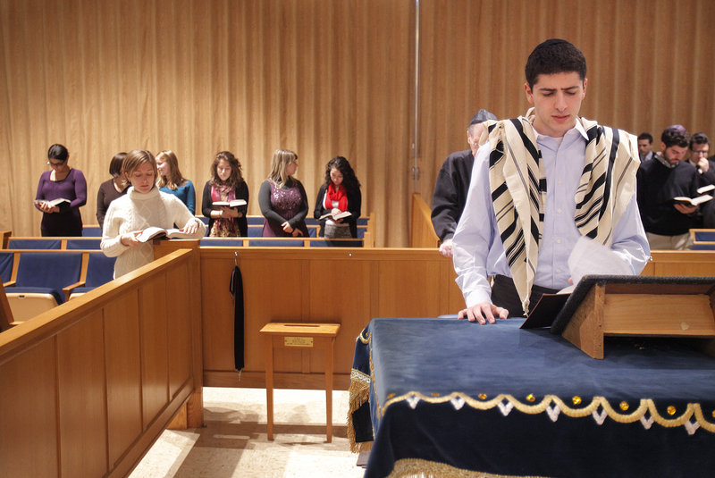 Jacob Agi, a student at Brandeis University, leads afternoon prayers Friday before the start of the Shabbat eve service at Shaarey Tphiloh Synagogue in Portland. College students are spending a weekend at the synagogue to learn more about orthodox Jewish life.
