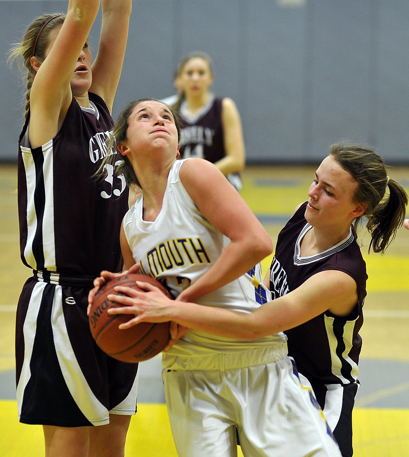 Jackie Doyle of Falmouth tries to go up for a shot while guarded by Greely’s Megan Coale, right, and Jaclyn Storey during Friday night’s game at Falmouth.