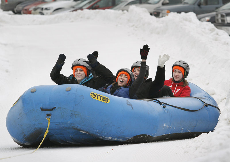 Hockey players on the Edward Little/Leavitt girls team test the snow-rafting hill at Lost Valley Ski Area. They are, from left, Taylor Landry, Holly Gallup, Amanda Grenier and Kayla Royer. The raft rides, a fundraiser for the hockey team, were stopped on Saturday because conditions weren’t suitable, but they are planned for noon to 4 p.m. today.