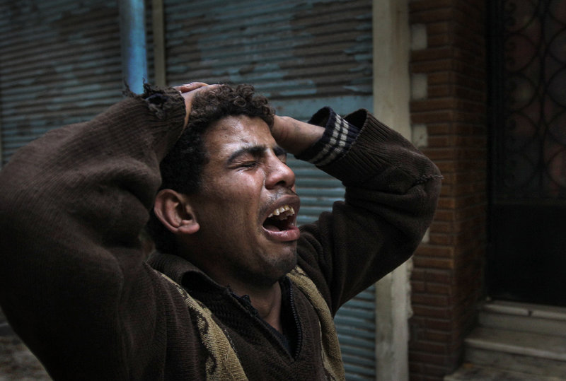 A protester in Tahrir Square cries out Saturday after seeing the body of another who was shot by police moments earlier.