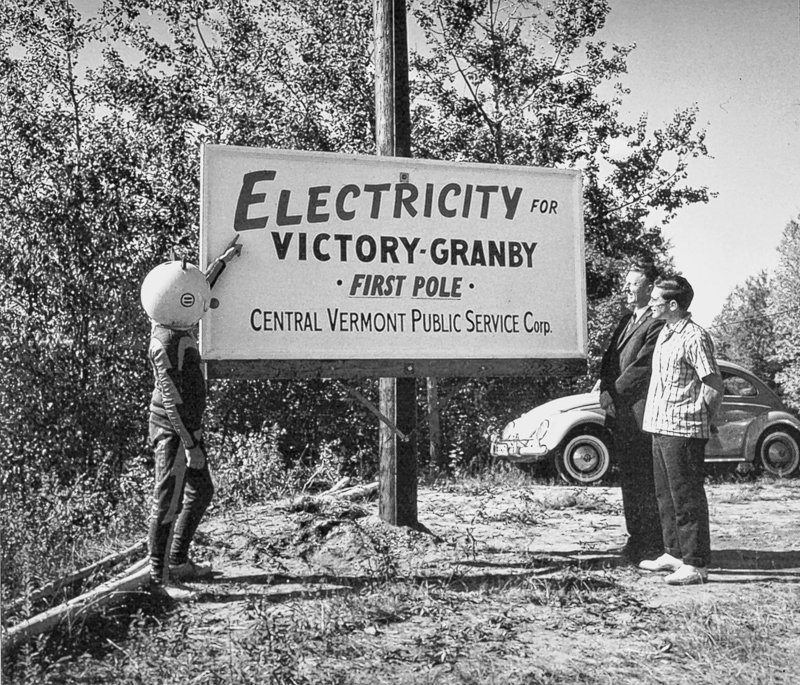 A sign is displayed during rural electrification in this photo provided by Central Vermont Public Service. In northern Vermont, it took until the 1960s to run power lines to some towns. These days, rural residents await broadband Internet access.
