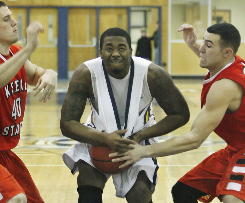 Otis Smith of the University of Southern Maine pulls a rebound away from Keene State's Nicco DeMasco, left, and Cody Snow during a Little East Conference men's basketball game Saturday. Keene State held off the Huskies, 72-67.