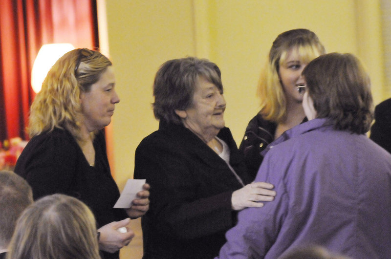 Megan Waterman's mother, Lorraine Ela, left, and grandmother Muriel Benner, center, speak with family and friends before a memorial service for Waterman in Portland on Sunday. Police believe she was murdered by a serial killer.