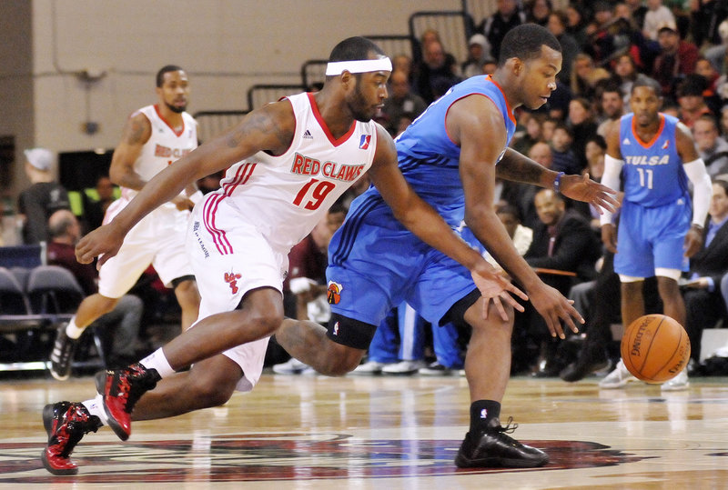 Maine's Mario West, left, tries to steal the ball Sunday in the Red Claws' 109-106 win over Tulsa. The Red Claws came up with 20 steals, including a league record-tying nine by Avery Bradley.