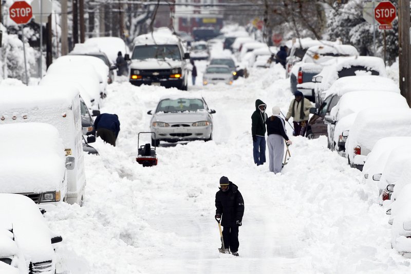 A young pedestrian makes his way down a snow-covered street after a winter storm in Philadelphia last week. Scientists who accept climate change cite several reasons for an increase in snow, including the loss of Arctic sea ice and the effect that change has on the winds circling the North Pole.