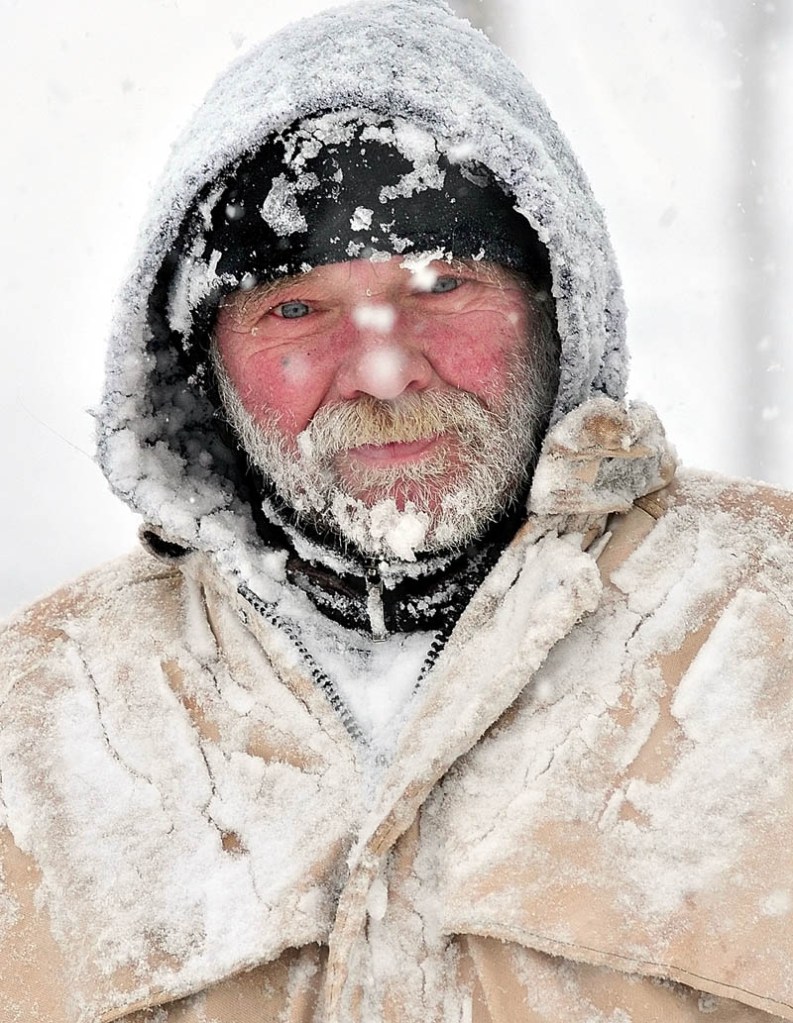 WELCOME TO MAINE: Bob Marden's face, beard and clothes are covered with snow while walking in Watervillle during Wednesday snowstorm. "It's great out here," Marden said. "We're in Maine."
