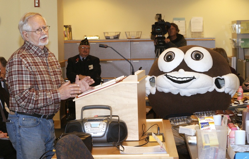 John Linscott, who wrote lyrics about whoopie pies, testifies last month in Augusta under the watchful eyes of a man dressed as a whoopie pie. On Monday, a legislative panel amended a proposed bill to say that the whoopie pie would be the state’s official “treat.”