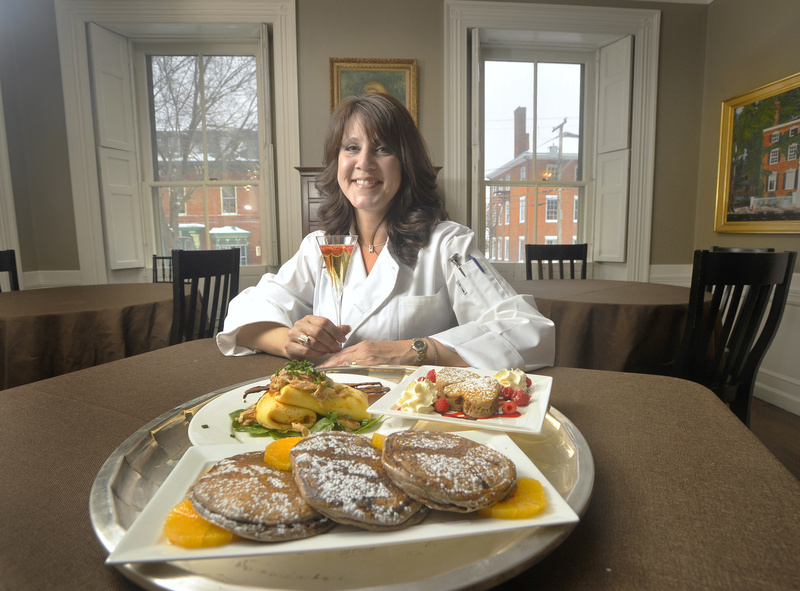 Dana Moos shows off her chocolate ricotta pancakes, including a version for the kids to help prepare for their parents, and a dish of ricotta, parmesan and asparagus crepes with Maine crab and sherry butter served with candied pepper bacon. Moos is in the dining room of the Danforth Inn on Portland's West End.