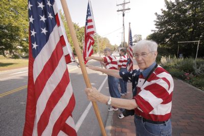 JoAnn Miller, Elaine Greene and Carmen Footer, front to back, known collectively as the Freeport Flag Ladies, wave to passing motorists on Main Street in Freeport on Tuesday, August 31, 2010. The three women have met for an hour every Tuesday since September 11, 2001.