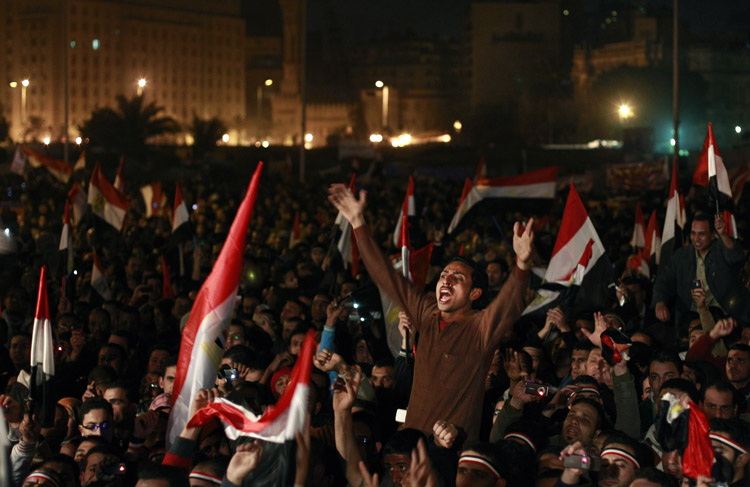 Egyptians celebrate the resignation of President Hosni Mubarak in Tahrir Square in downtown Cairo today.