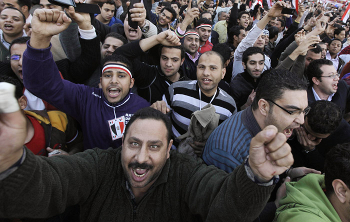 Cheering protesters react as high-ranking Egyptian Army Gen. Hassan El-Rueni, unseen, addresses the continuing anti-government demonstration in Tahrir Square in downtown Cairo today.