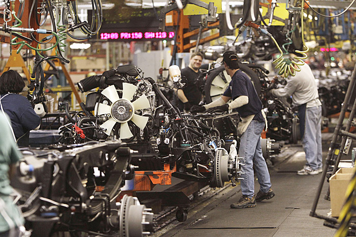 An engine is joined to the chassis on the General Motors Silverado and GMC Sierra heavy-duty pickups assembly line recently in Flint, Mich.