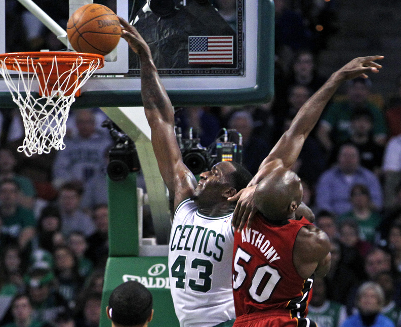 Kendrick Perkins of the Celtics scores over Heat center Joel Anthony in Sunday's game at Boston. The Celts won, 85-82.