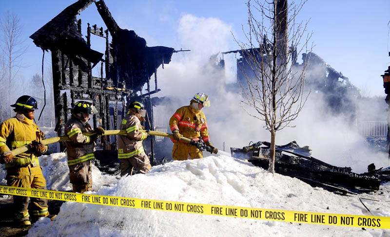 Firefighters extinguish a blaze in Readfield Wednesday that destroyed a home on Church Road.